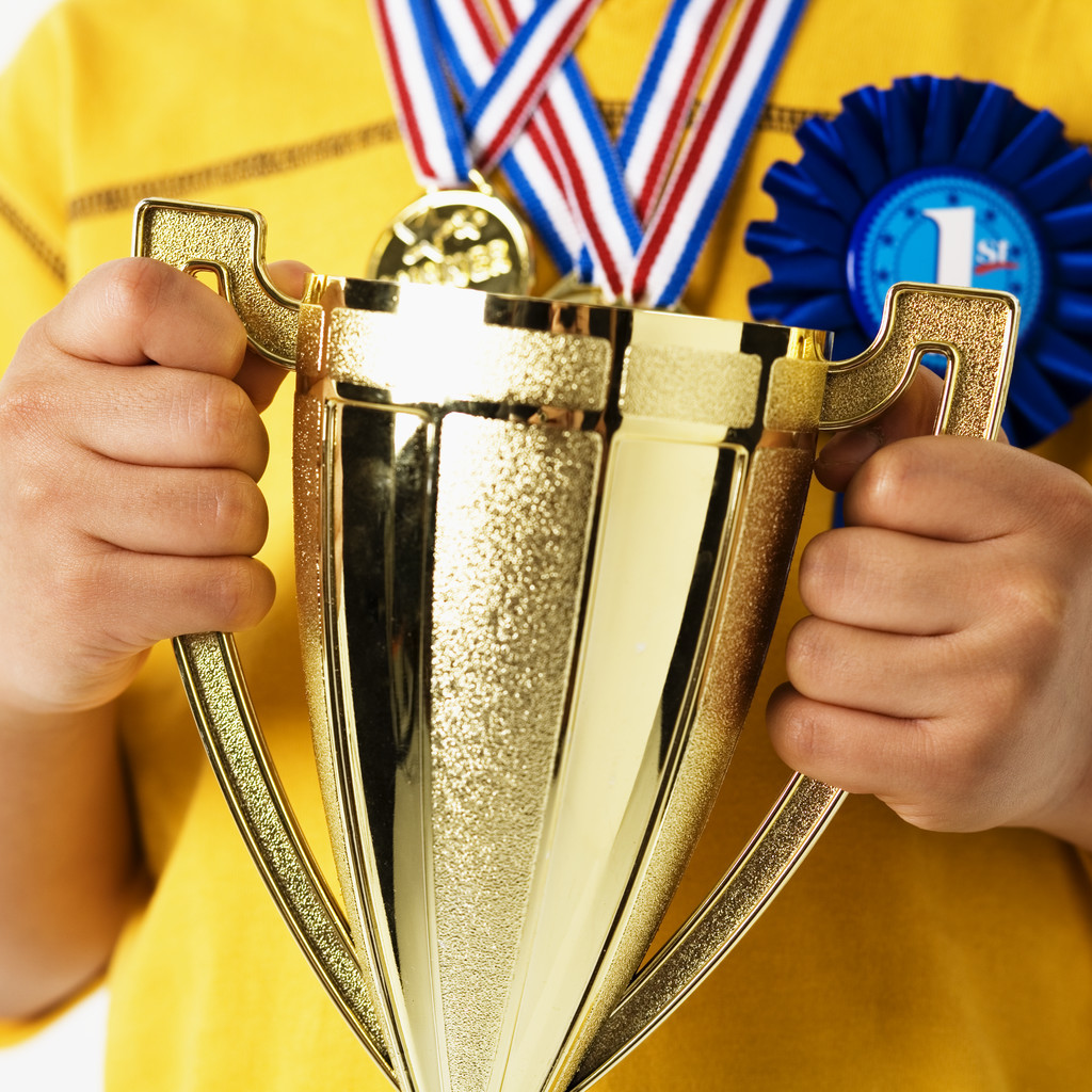 Child Holding Trophy --- Image by © Royalty-Free/Corbis